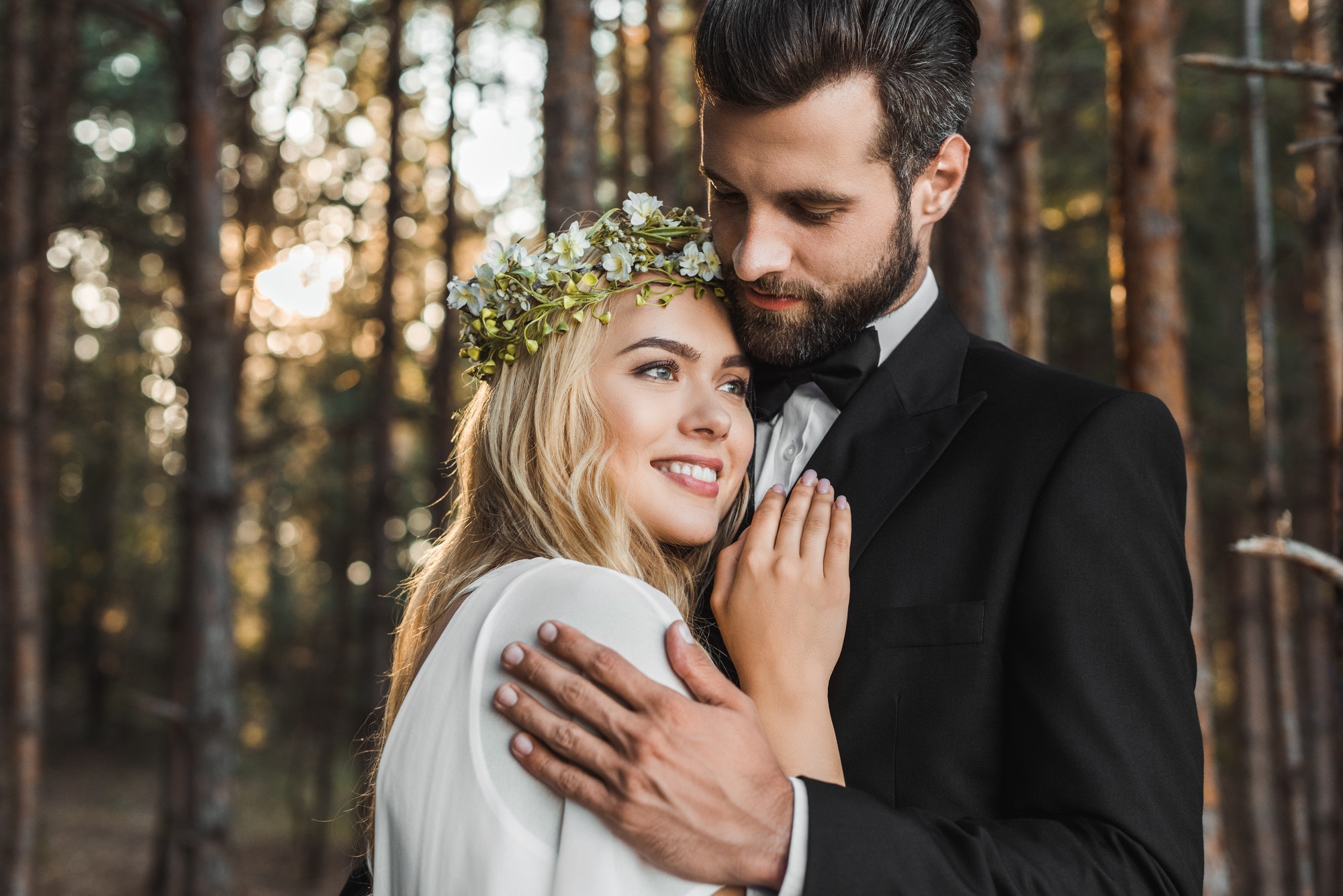 beautiful wedding couple hugging in forest