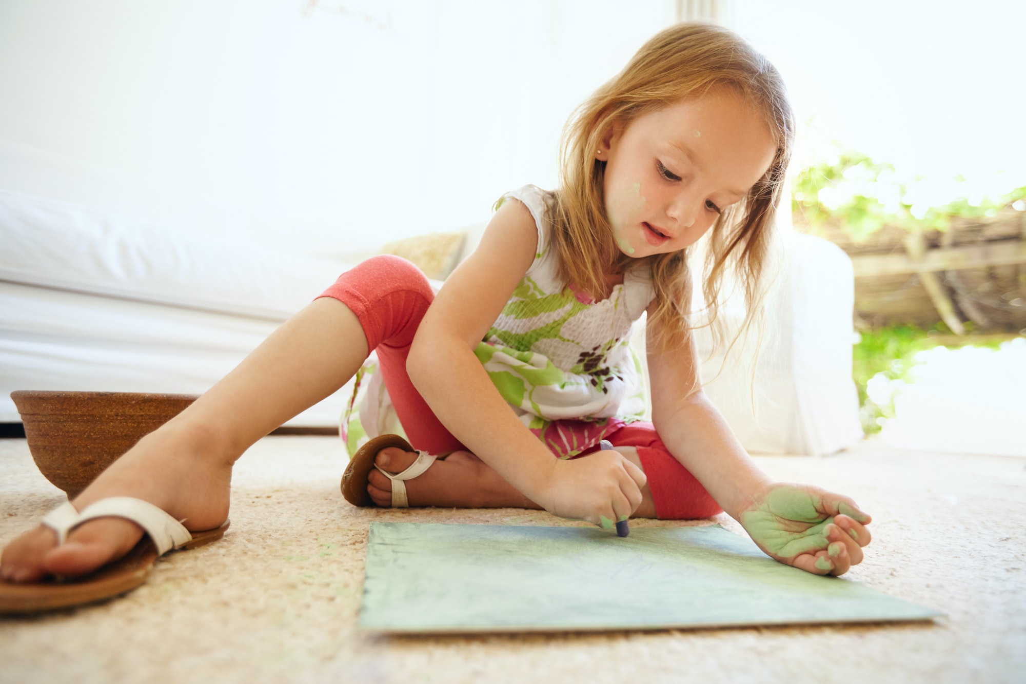 Little baby girl coloring picture at home